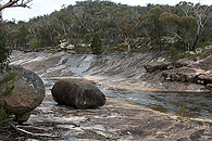 Water running down the granite banks.