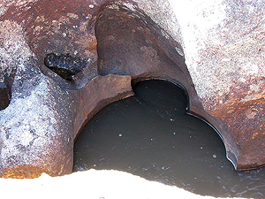 One of the many deep drill holes cut into the channel of  the chute.