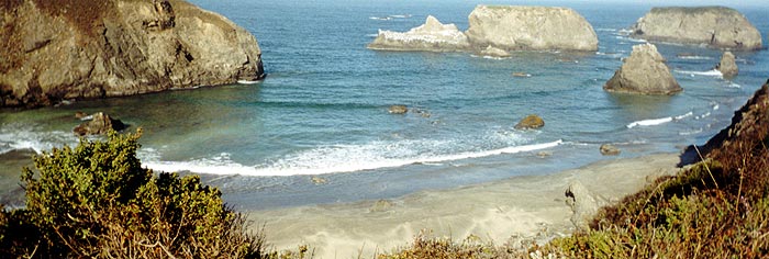 Panoramic view of beach and rocks.